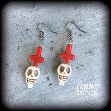 Load image into Gallery viewer, Skull earrings, Voodoo earrings, Los Muertos earrings, Santeria jewelry, Plug earrings, Tunnel earrings, Red inverted cross, Pierced ears